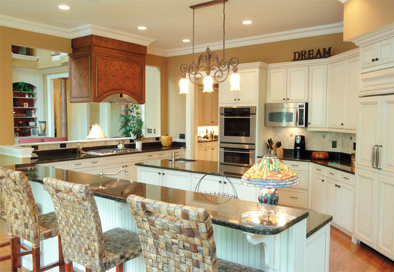 Spacious white kitchen in mustard-colored walls